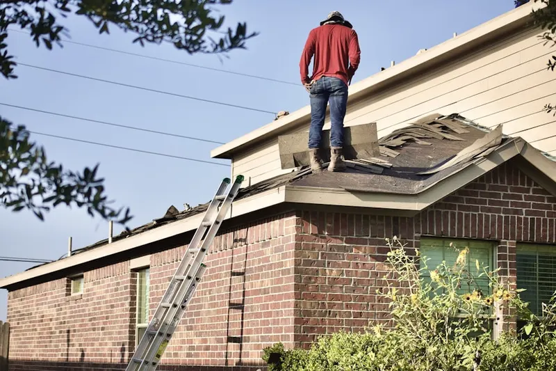 Professional roofer working on a residential roof in Mills Park Neighborhood